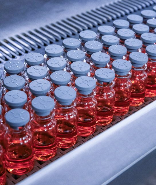 Vials of liquid in 4 rows on a machine